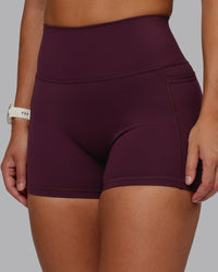 Woman wearing Fusion Ultra High-Rise 4" Short Pockets - Cherry Lacquer | Model:Lyss | Size:S