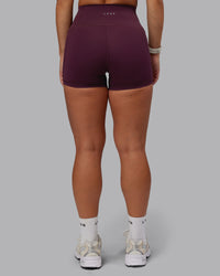 Woman wearing Fusion Ultra High-Rise 4" Short Pockets - Cherry Lacquer | Set:true | Angle:back | Model:Lyss | Size:S