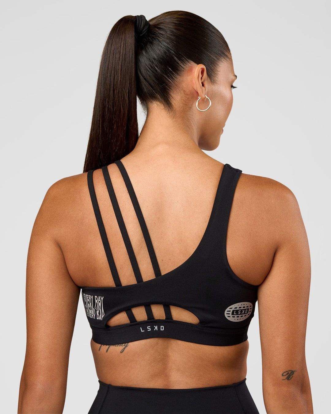 Woman wearing Galvanise Hype Graphic Sports Bra 2.0 - Black-Alloy | Model:Rhiley | Size:S