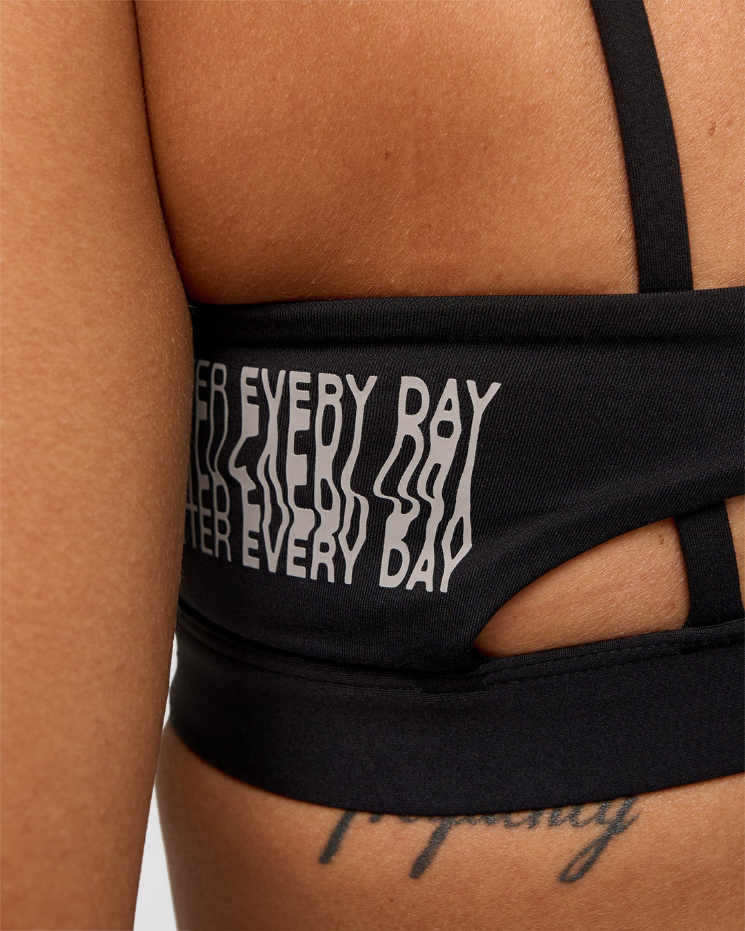 Woman wearing Galvanise Hype Graphic Sports Bra 2.0 - Black-Alloy | Model:Rhiley | Size:S