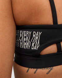 Woman wearing Galvanise Hype Graphic Sports Bra 2.0 - Black-Alloy | Model:Rhiley | Size:S