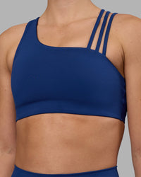 Woman wearing Galvanise Sports Bra 2.0 - Midnight Blue | Model:Charlize | Size:S
