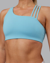Woman wearing Galvanise Sports Bra 2.0 - Retro Blue | Model:Hannah | Size:S