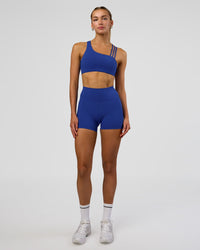 Woman wearing Galvanise Sports Bra 2.0 - Electric Indigo | Model:Evie | Size:S