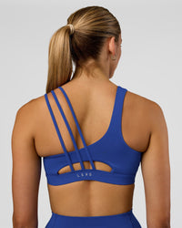 Woman wearing Galvanise Sports Bra 2.0 - Electric Indigo | Model:Evie | Size:S