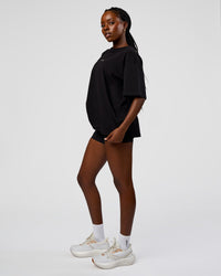 Woman wearing Go-To Run Club FLXCotton Oversized Tee - Black-Marshmallow | Model:Ellie | Size:S