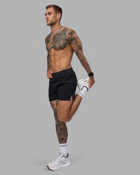 Man wearing Hybrid 5" Short - Black-Reflective | Model:Tommy | Size:S