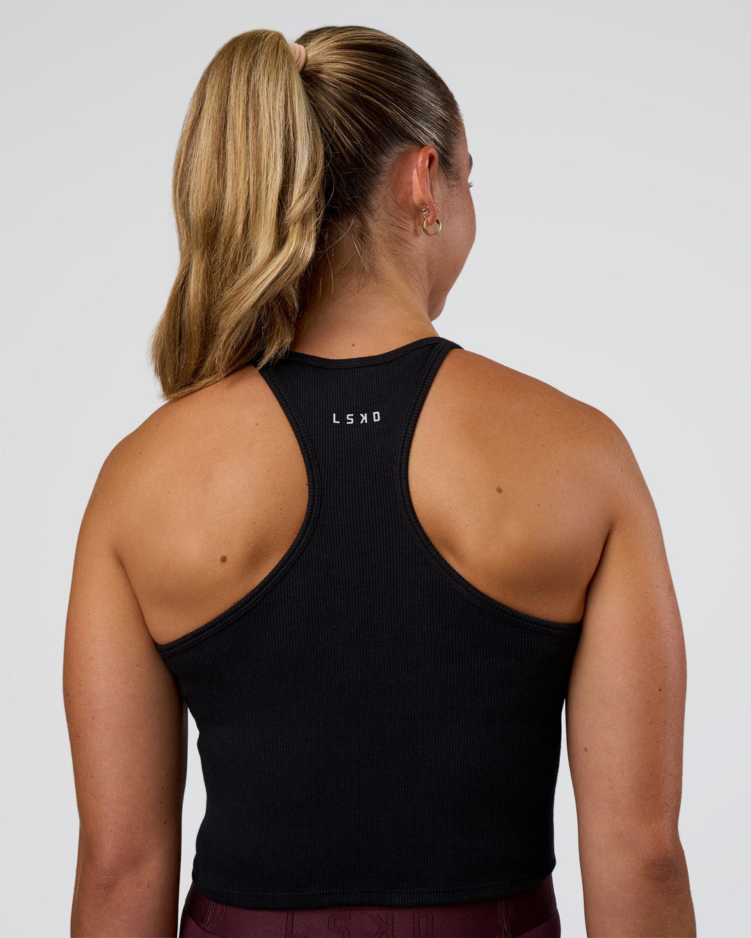 Woman wearing Ignite High Neck Tank - Black | Model:Sav | Size:S