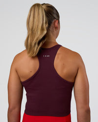 Woman wearing Ignite High Neck Tank - Cherry Lacquer | Model:Sav | Size:S