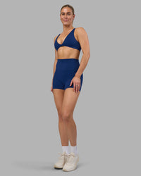 Woman wearing Impulse Reversible Sports Bra - Midnight Blue | Model:Hannah | Size:S