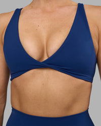 Woman wearing Impulse Reversible Sports Bra - Midnight Blue | Model:Hannah | Size:S