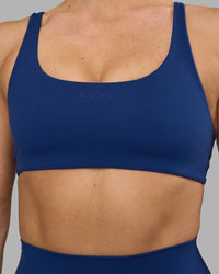 Woman wearing Impulse Reversible Sports Bra - Midnight Blue | Model:Hannah | Size:S