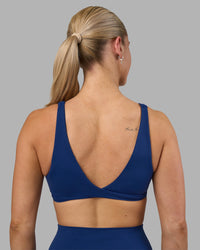 Woman wearing Impulse Reversible Sports Bra - Midnight Blue | Model:Hannah | Size:S