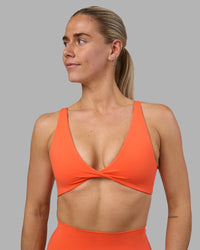 Woman wearing Impulse Reversible Sports Bra - Ultra Orange | Model:Hannah | Size:S