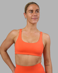 Woman wearing Impulse Reversible Sports Bra - Ultra Orange | Model:Hannah | Size:S