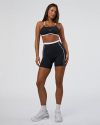 Woman wearing Liberate Contrast High-Rise 6" Short Pockets - Black-White | Model:Bianca | Size:S