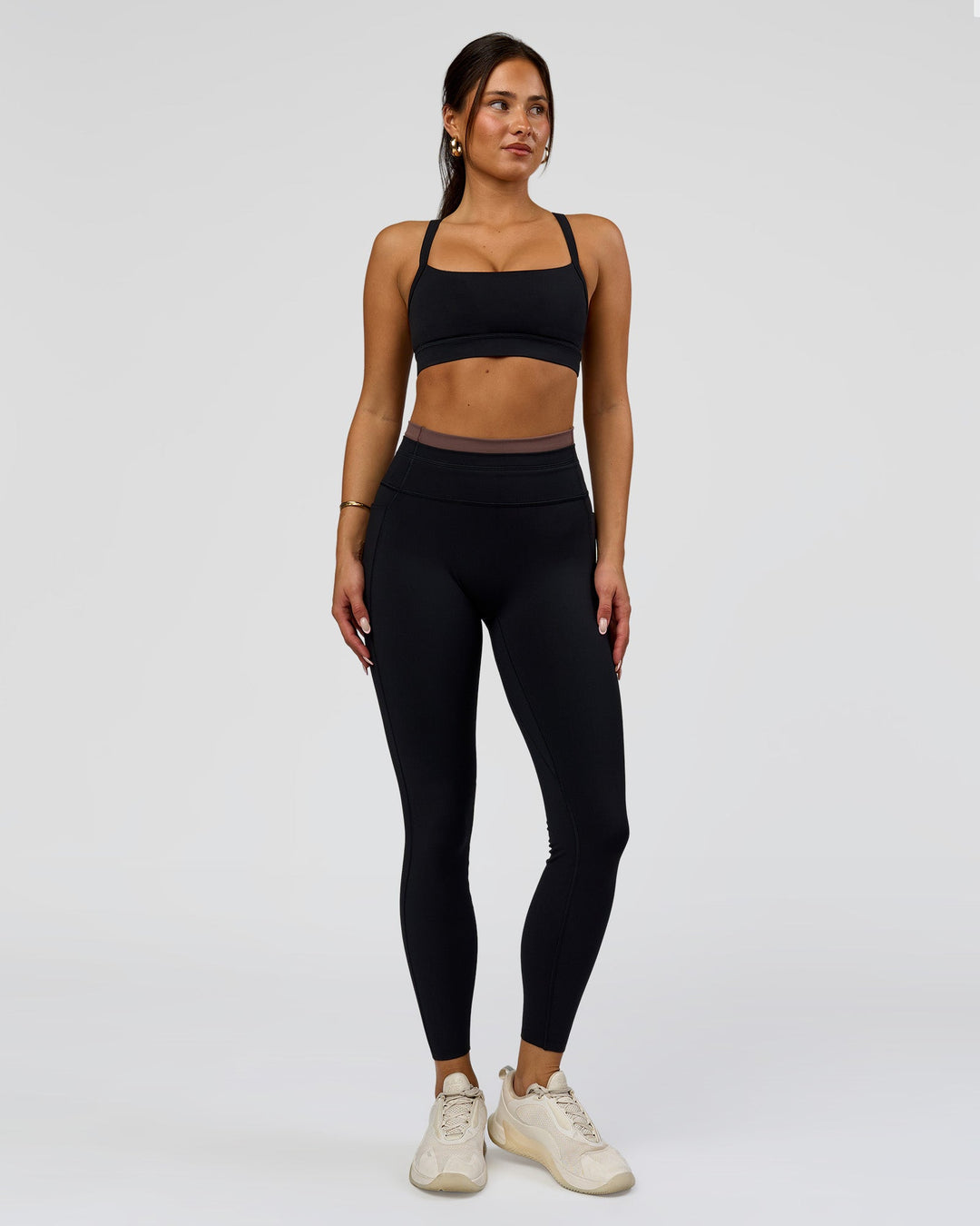 Woman wearing Liberate High-Rise Full Length Legging Pockets in Black-Cocoa Powder | Model:Bianca | Size:S