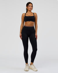 Woman wearing Liberate High-Rise Full Length Legging Pockets in Black-Cocoa Powder | Model:Bianca | Size:S