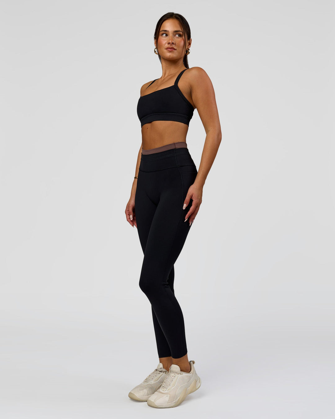 Woman wearing Liberate High-Rise Full Length Legging Pockets in Black-Cocoa Powder | Model:Bianca | Size:S
