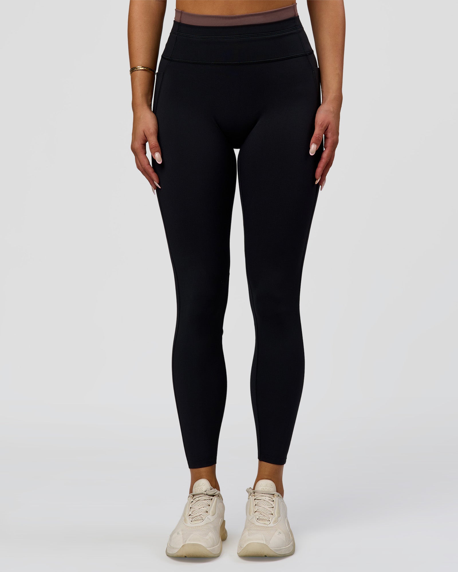 Woman wearing Liberate High-Rise Full Length Legging Pockets in Black-Cocoa Powder | Model:Bianca | Size:S