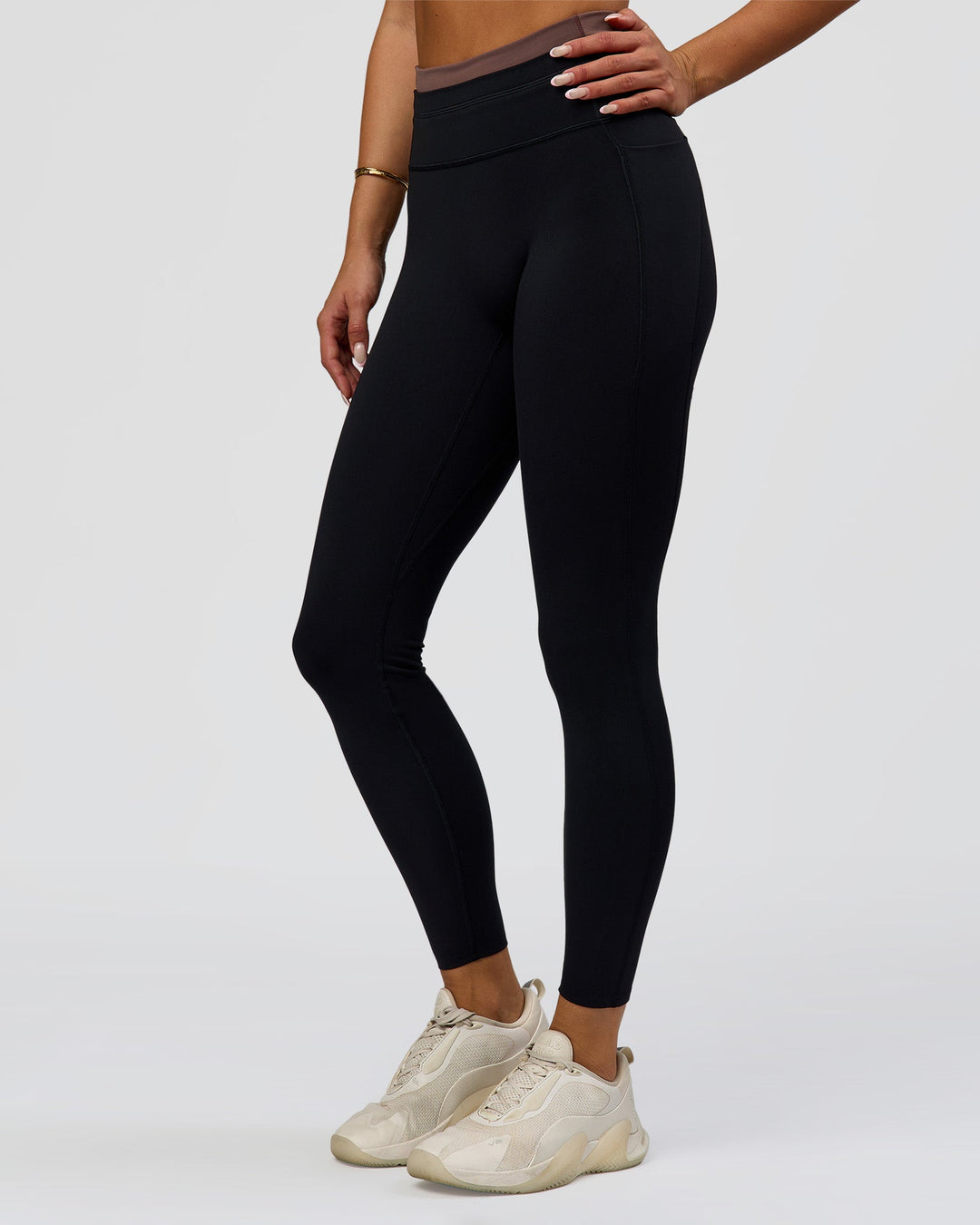 Woman wearing Liberate High-Rise Full Length Legging Pockets in Black-Cocoa Powder | Model:Bianca | Size:S