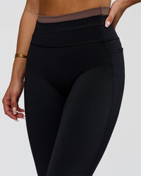 Woman wearing Liberate High-Rise Full Length Legging Pockets in Black-Cocoa Powder | Model:Bianca | Size:S