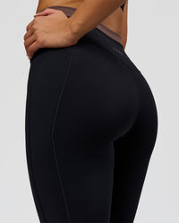 Woman wearing Liberate High-Rise Full Length Legging Pockets in Black-Cocoa Powder | Model:Bianca | Size:S