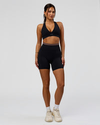 Woman wearing Liberate High-Rise 6" Short Pockets in Black-Cocoa Powder | Model:Bianca | Size:S