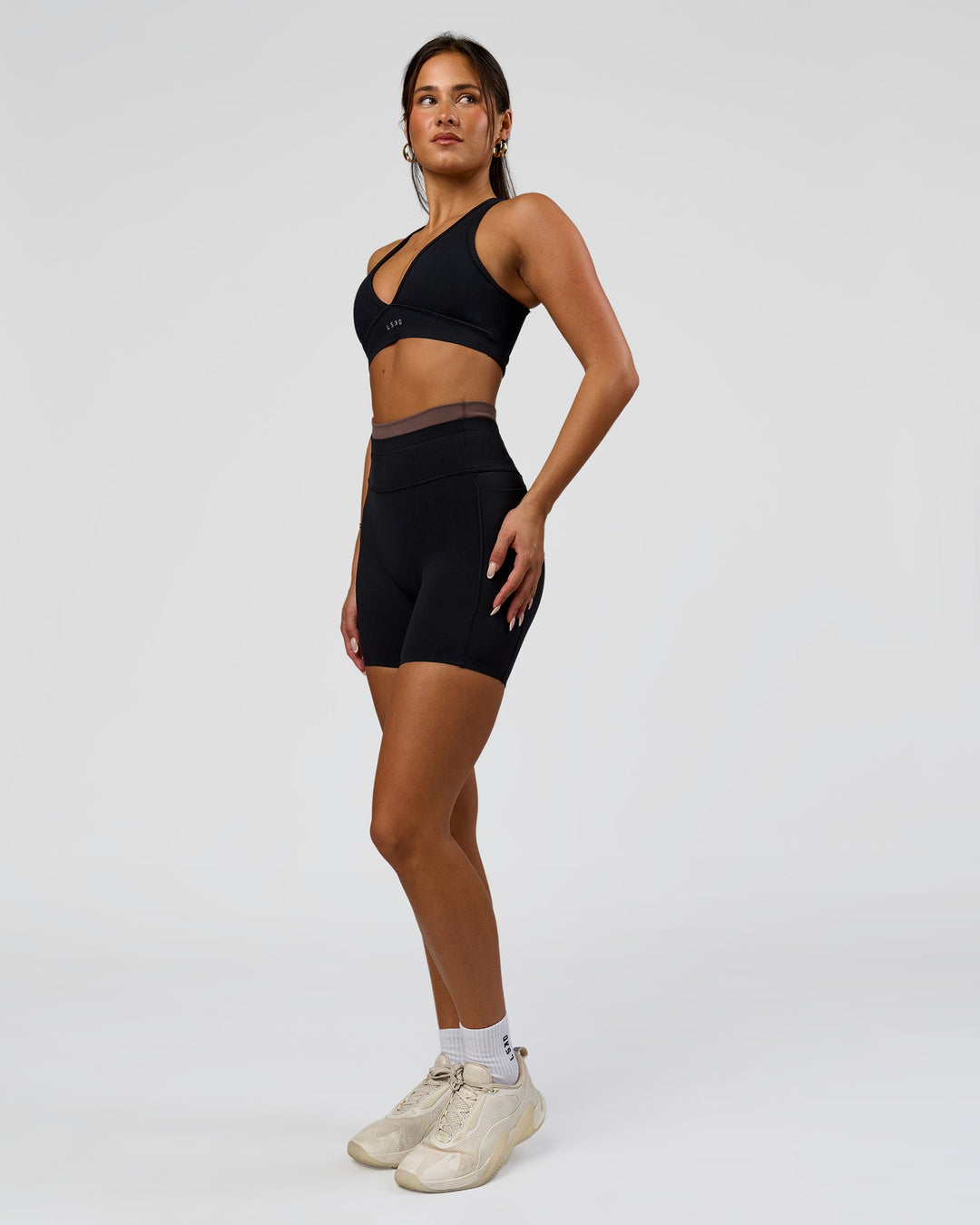 Woman wearing Liberate High-Rise 6" Short Pockets in Black-Cocoa Powder | Model:Bianca | Size:S