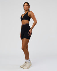 Woman wearing Liberate High-Rise 6" Short Pockets in Black-Cocoa Powder | Model:Bianca | Size:S