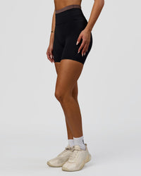 Woman wearing Liberate High-Rise 6" Short Pockets in Black-Cocoa Powder | Model:Bianca | Size:S