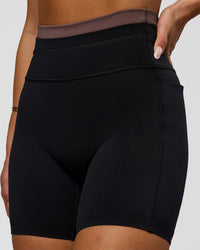 Woman wearing Liberate High-Rise 6" Short Pockets in Black-Cocoa Powder | Model:Bianca | Size:S