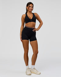 Woman wearing Liberate High-Rise 4" Short Pockets in Black-Cocoa Powder | Model:Bianca | Size:S