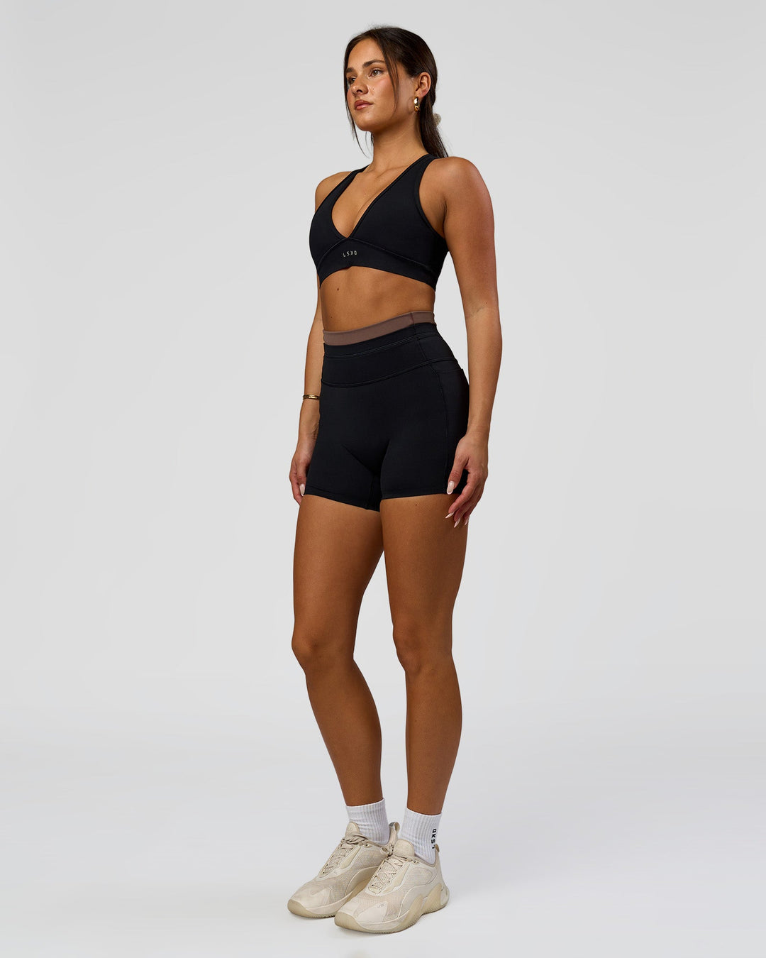Woman wearing Liberate High-Rise 4" Short Pockets in Black-Cocoa Powder | Model:Bianca | Size:S