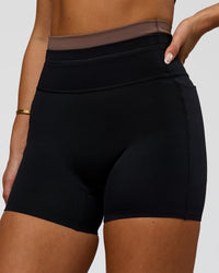 Woman wearing Liberate High-Rise 4" Short Pockets in Black-Cocoa Powder | Model:Bianca | Size:S