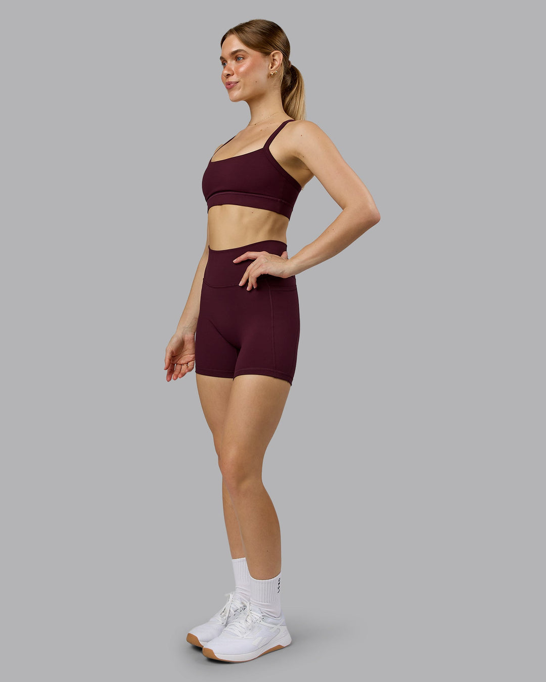 Woman wearing Momentum Sports Bra - Cherry Lacquer | Model:Emilie | Size:S - view 3
