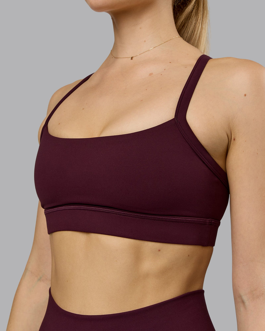 Woman wearing Momentum Sports Bra - Cherry Lacquer | Model:Emilie | Size:S - view 7