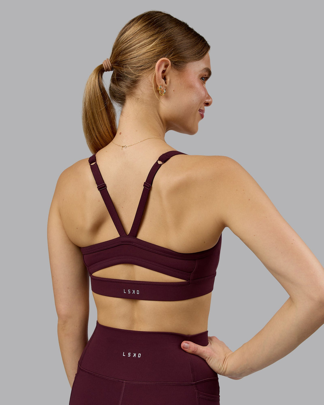 Woman wearing Momentum Sports Bra - Cherry Lacquer | Model:Emilie | Size:S - view 6