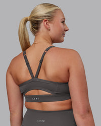 Woman wearing Momentum Sports Bra D/DD/E - Dark Storm | Model:Lilli | Size:S