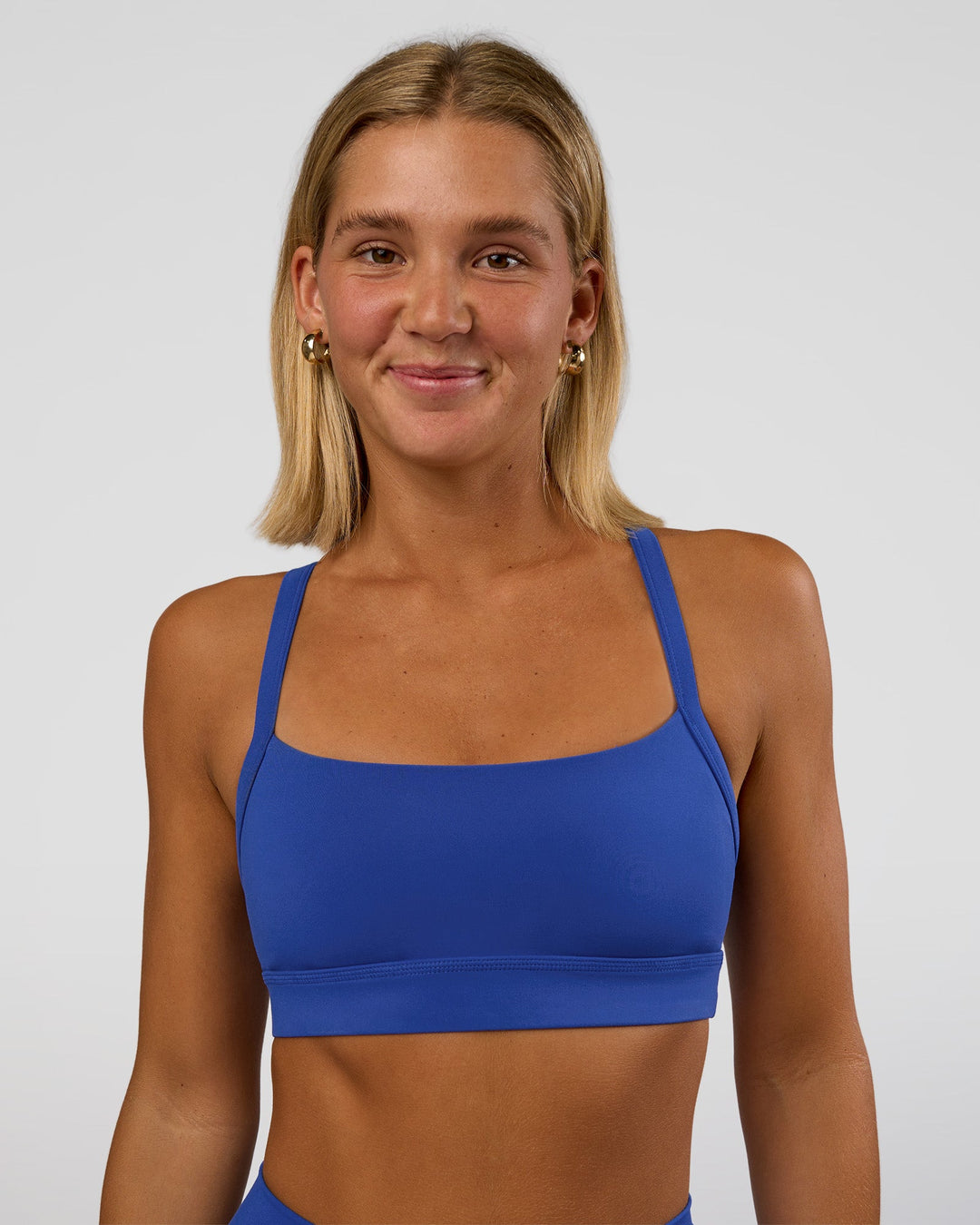 Woman wearing Momentum Sports Bra - Electric Indigo | Model:Amity | Size:S