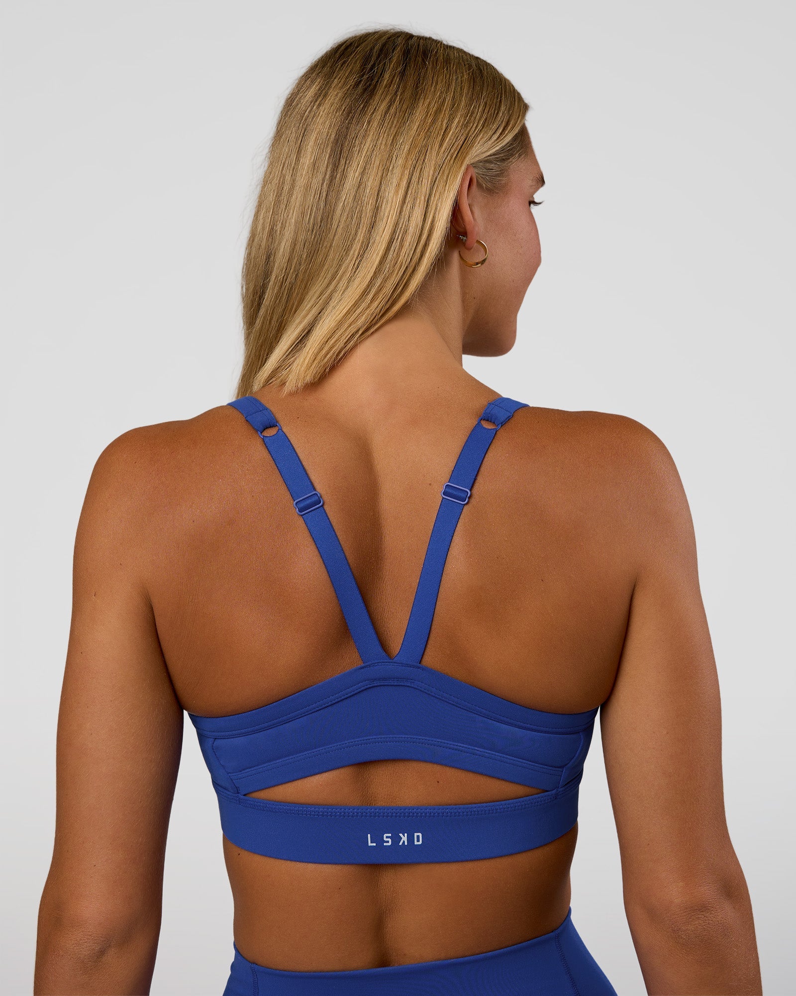 Woman wearing Momentum Sports Bra - Electric Indigo | Model:Amity | Size:S
