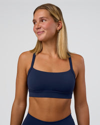 Woman wearing Momentum Sports Bra - Future Navy | Model:Amity | Size:S