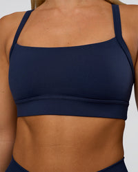 Woman wearing Momentum Sports Bra - Future Navy | Model:Amity | Size:S
