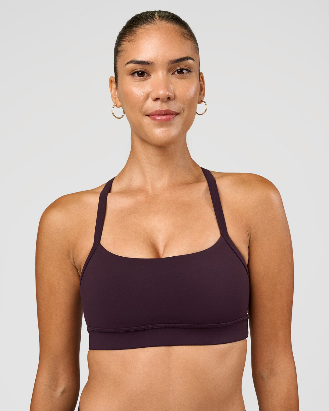 Woman wearing Momentum Sports Bra - Midnight Plum | Model:Rhiley | Size:S