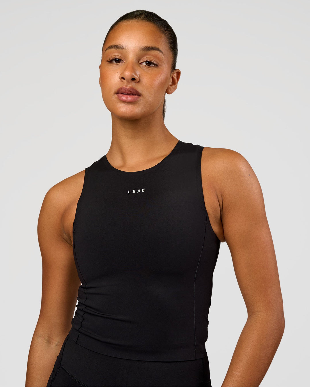 Woman wearing NyxRun Stash Tank - Black | Model:Rosie | Size:S