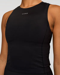 Woman wearing NyxRun Stash Tank - Black | Model:Rosie | Size:S