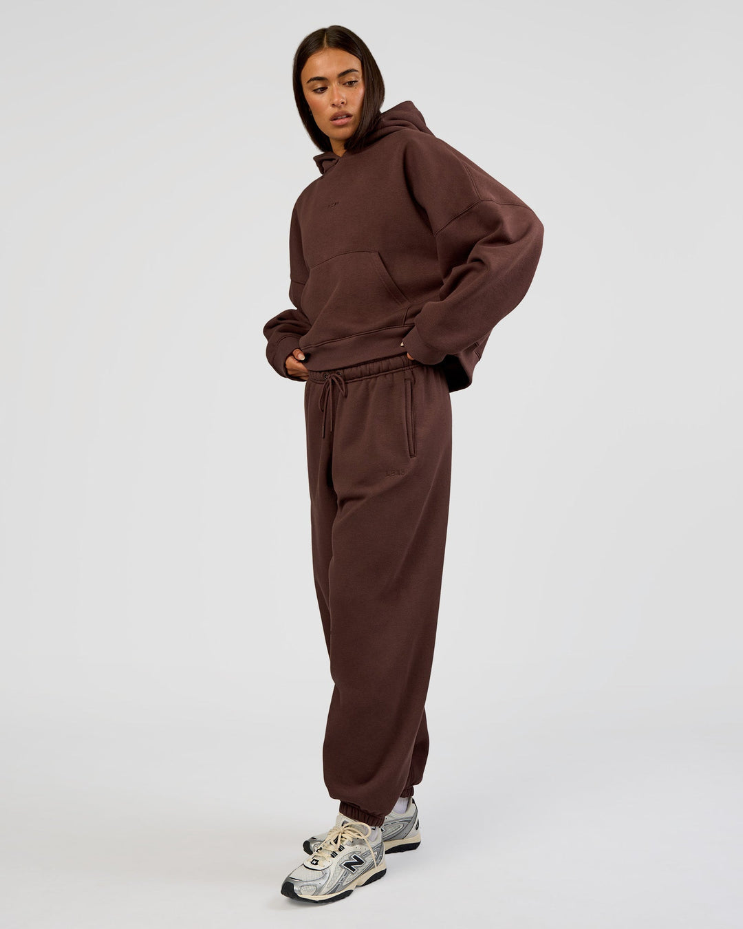 Woman wearing Post Train Hoodie - Hot Chocolate | Model:Ruby | Size:S