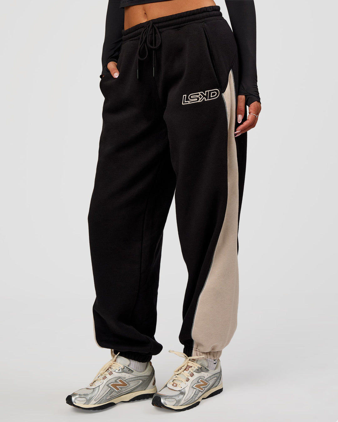 Woman wearing Power Play Stitch Up Fleece Sweat Pant - Black-Shale Beige | Model:Bianca | Size:S
