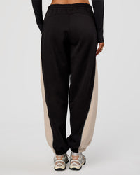 Woman wearing Power Play Stitch Up Fleece Sweat Pant - Black-Shale Beige | Model:Bianca | Size:S