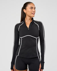 Woman wearing Power Quarter Zip Jacket - Black | Model:Rhiley | Size:S